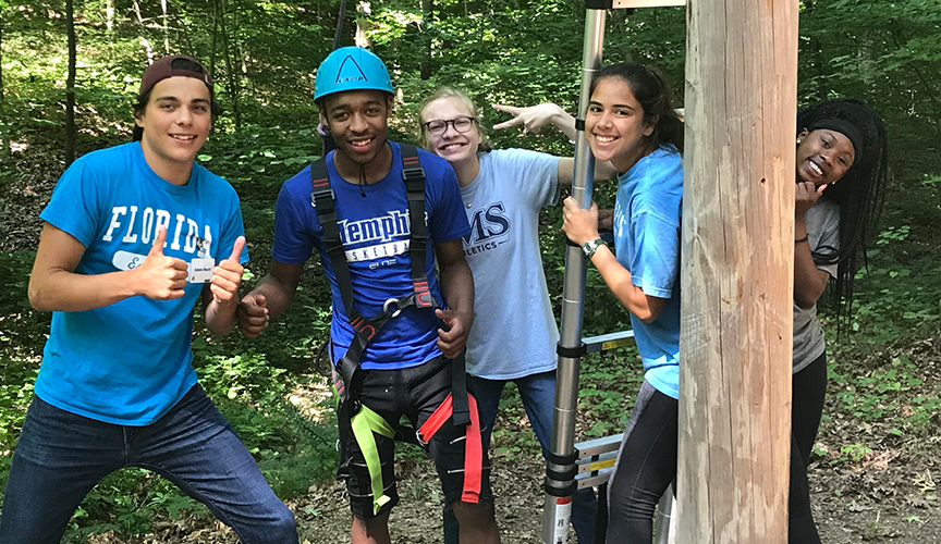 Teenagers enjoying climbing at Cardiac Kids Camp.